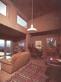 Clerestory windows provide daylighting and solar heating. Concrete mass stabilizes temperatures.